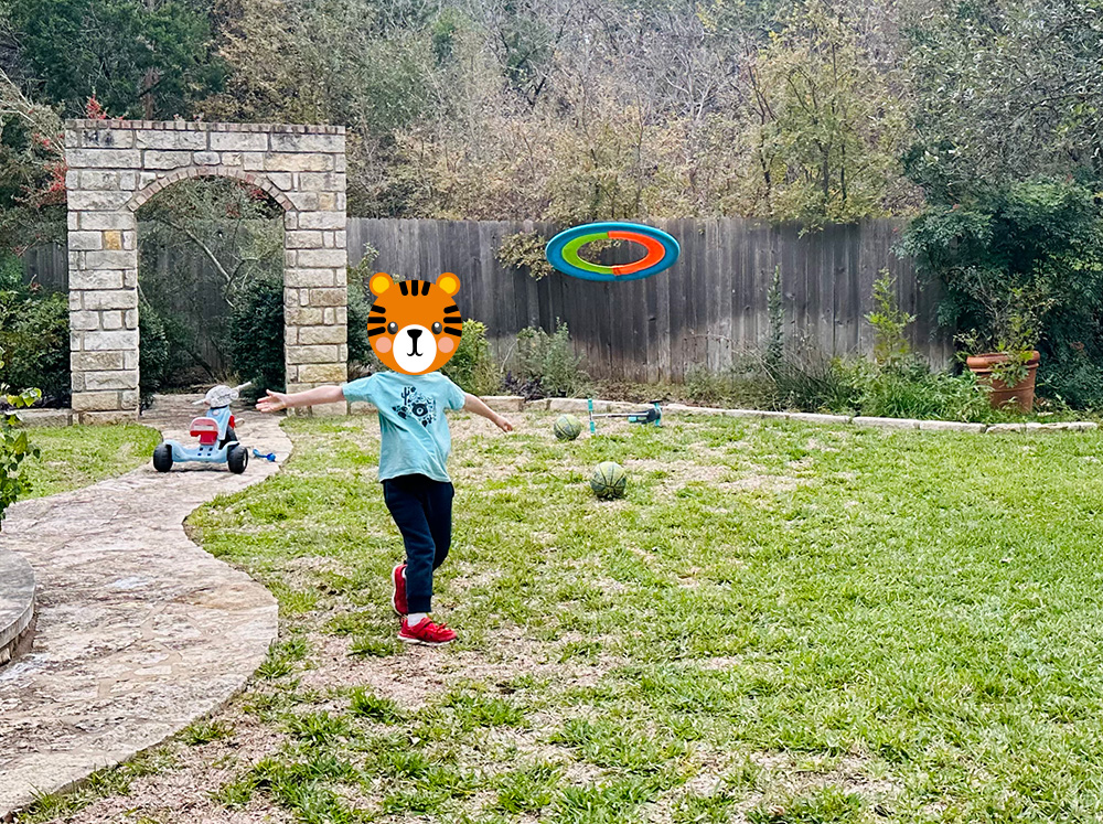 My son throwing the Beamo 16 inch flying hoop in our back yard